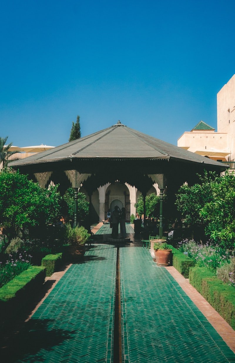 An ornate garden pavilion with green tiled paths